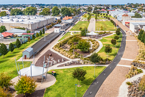 Old Mount Gambier railway station and shunting yard converted into open space in town centre: new vibrant recreation area blended with history coexisting with industry and retail shopping precinct. Sunshades, landscaped gardens, paved path, sculptures.