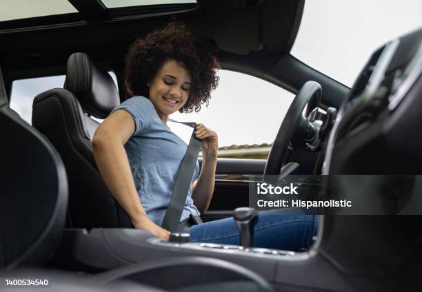Female Driver Fastening Her Seat Belt In Her Car Stock Photo - Download Image Now - Seat Belt, Car, One Person