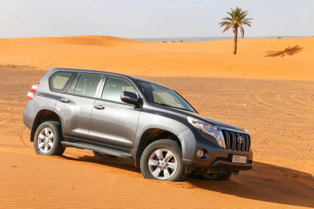 Toyota Land Cruiser Prado, a 4x4 offroad vehicle (SUV) driving in desert in Morocco.