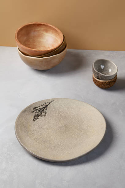 istock Ceramic dishware in modern style on gray stone background. Empty Handmade crockery in minimalistic composition. Pottery plate on concrete background. 1400536281