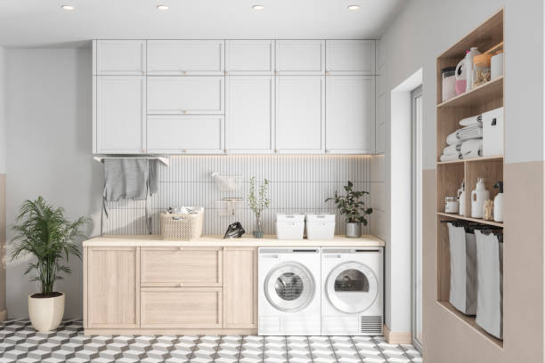 Modern Laundry Room With Washing Machine, Dryer And Cabinets stock photo