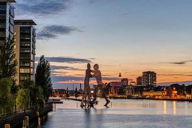 The river Spree in Berlin with the Molecule Men after sunset