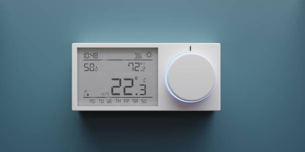 istock Digital thermostat on blue wall. Home heating temperature control device close up. 3d render 1400546267