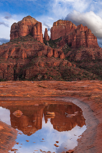 Cathedral Rock in Sedona, Arizona reflecting off a pool of water after a storm