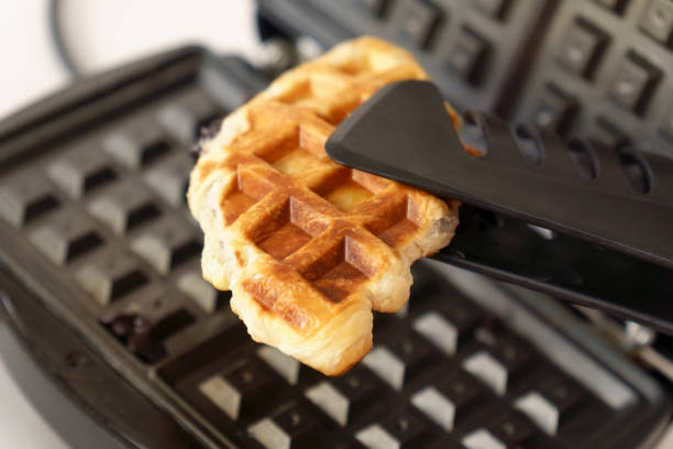 istock Croffle croissant and waffle. Soft and layered croissant dough is squeezed with a waffle iron and fried 1400549529