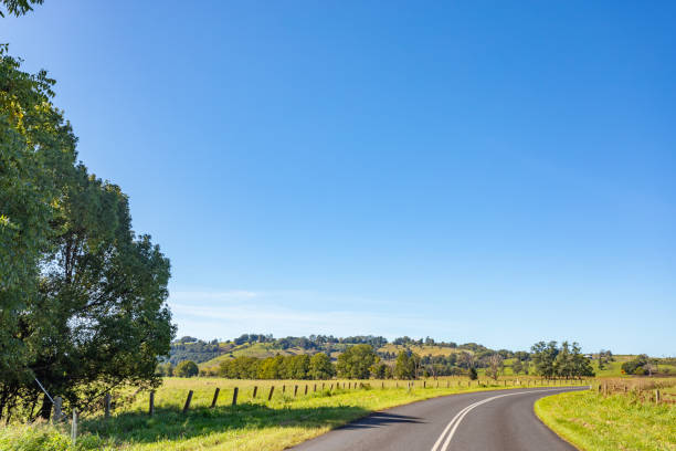 istock Rural country road under sunny clear blue sky 1400550822