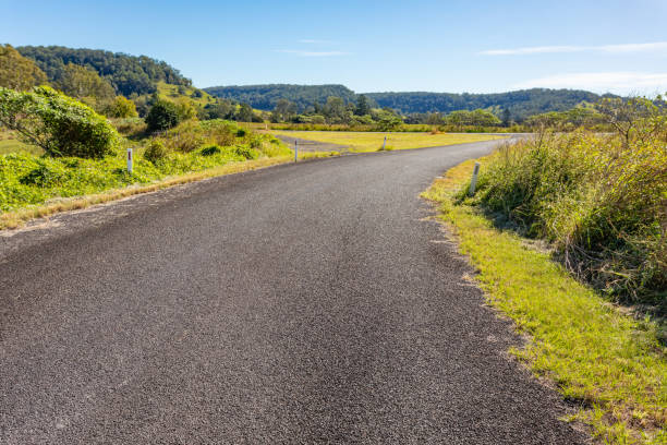 istock Rural country road under sunny clear blue sky 1400550904