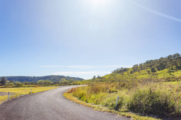 istock Rural country road under sunny clear blue sky 1400550912