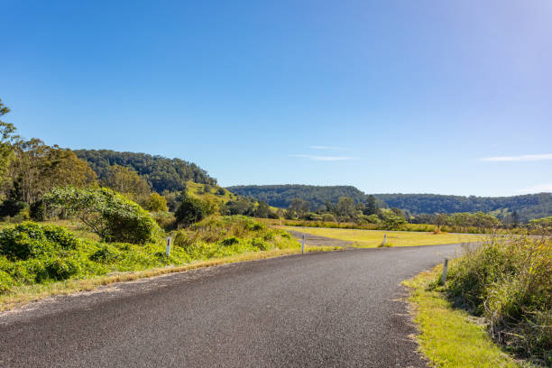 istock Rural country road under sunny clear blue sky 1400550915