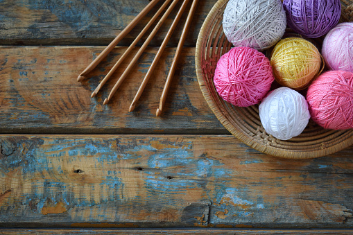 The equipment for knitting and crochet hook, colorful rainbow cotton yarn, ball of threads, wool. Handmade crocheting crafts. DIY concept. Copy space