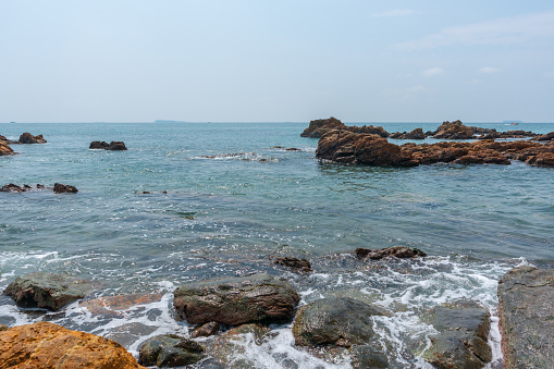 Rocky coastline and Green Island in Shenzhen Bay, China