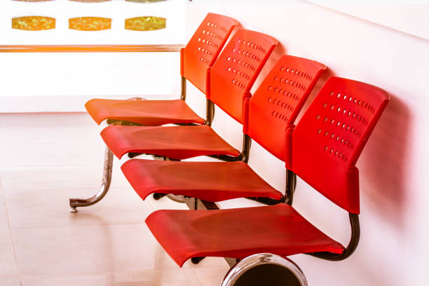 istock Red chairs lined up in front of the white room. 1400556900