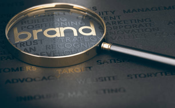 Brand management, Branding or rebranding concept. Brand marketing and management, branding or rebranding concept. 3d illustration of a magnifying glass over golden and black words. image focus technique stock pictures, royalty-free photos & images
