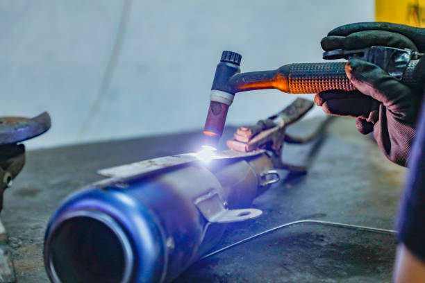 istock Closeup welding motorcycle frame in workshop, bike silencer 1400559324