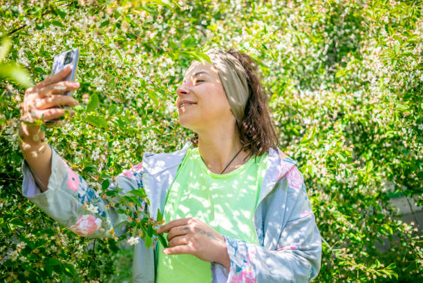 istock brunette woman with blooming cherry tree 1400559552