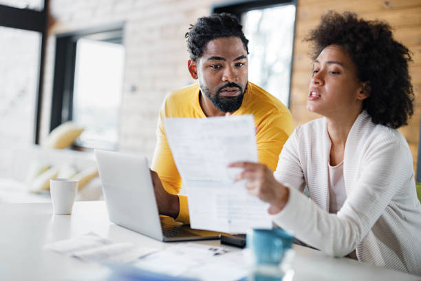 istock African American couple paying their home bills over a computer. 1400560500
