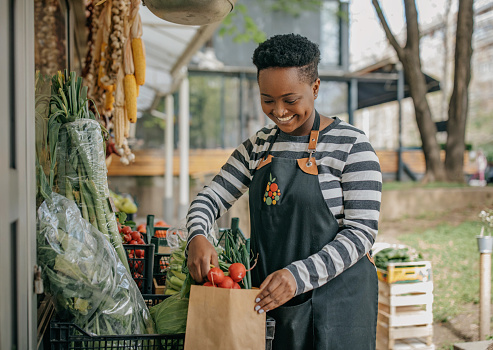 Smiling African-American  woman working at a local food market