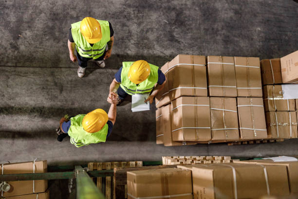 istock Above view of manual workers greeting in a warehouse. 1400561202