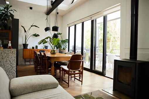 Interior of the living room, dining area and modern kitchen in a bright open plan home