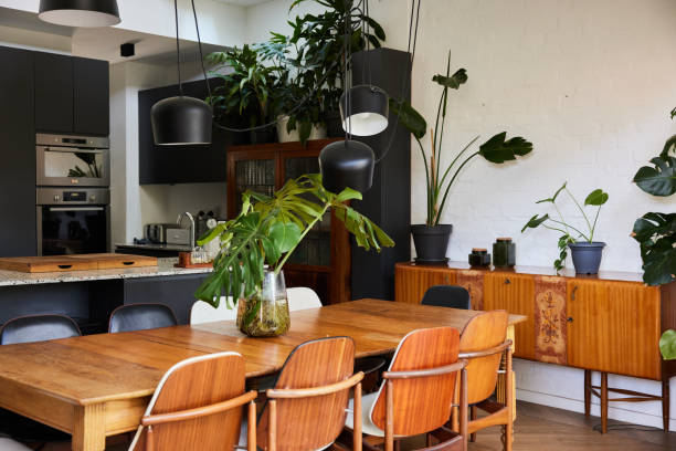 istock Large dining table in a home with a modern kitchen in the background 1400562403
