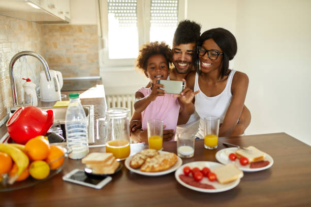 istock Cheerful family taking Selfie during breakfast 1400563358