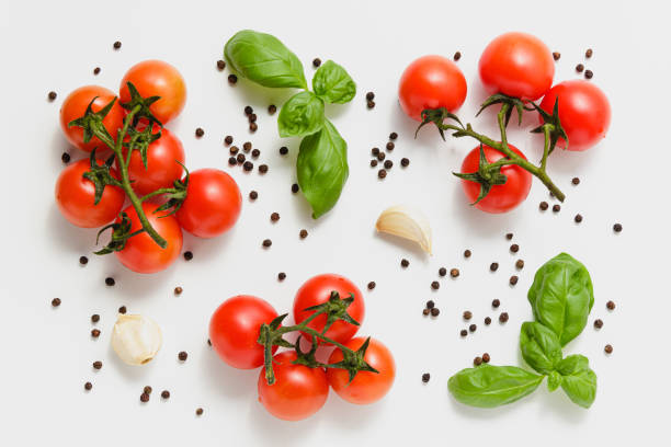 istock Cherry tomatoes on branches with green basil and garlic. 1400564673