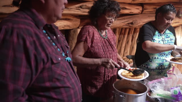 Indigenous Navajo Family serving a traditional chili meal
