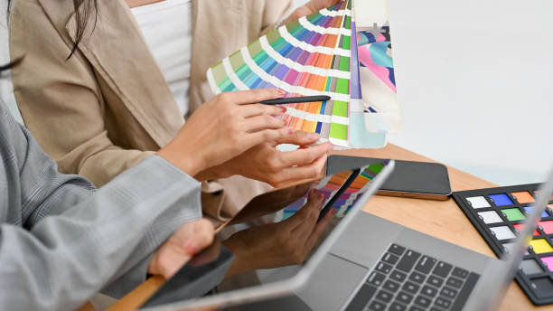 istock Two of a graphic designers are discussing and planning the web colour for their project together. 1400565148