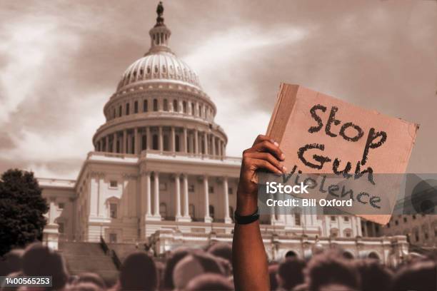 Stop Gun Violence Protester Holding Sign In Front Of Capital Building Stock Photo - Download Image Now