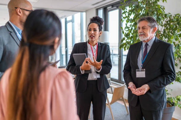 istock Groups of Executives Conversing in Office Reception Rooms 1400568023