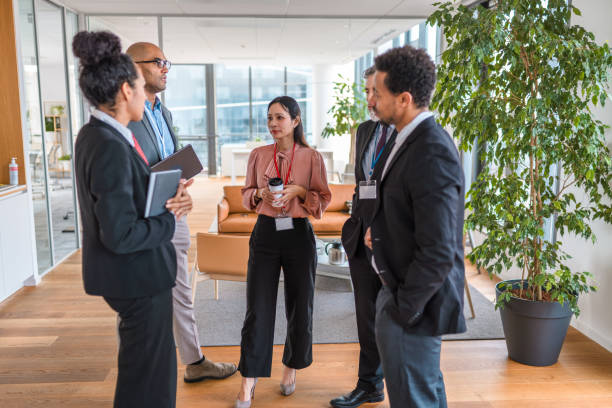 istock Multi-ethnic Group Of People Catching Up Before A Business Meeting 1400568046