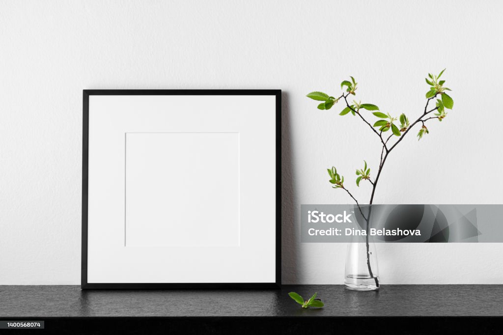 Frame mockup. Poster with plant in vase. Frame mockup. Poster with plant in vase. Black square photo frame with passepartout. Side view. Can be used as a template for designs and art works. Wall - Building Feature Stock Photo