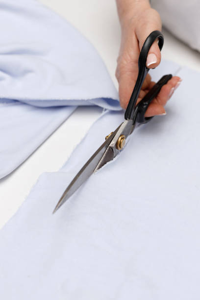 istock seamstresses resit the fabric with scissors 1400569491