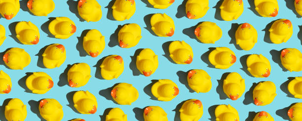 istock Collection of yellow rubber ducks on a blue background 1400569624