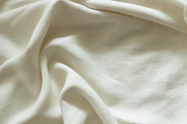 istock White crumpled linen fabric texture background. Natural linen organic eco textiles canvas background. Top view 1400570452