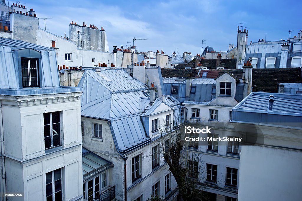 Paris neighborhood skyline View of a Paris neighborhood skyline, featuring mostly rooftops from the top floor of an apartment building in Paris, France. Apartment Stock Photo