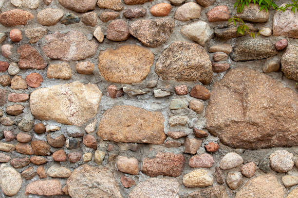 part of an old wall made of clay bricks and polished hewn stones stone brick wall of an old building, part of an old wall made of clay bricks and polished hewn stones roughhewn stock pictures, royalty-free photos & images