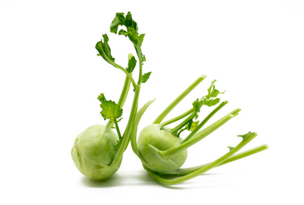 Fresh kohlrabi with green leaves isolated on white background.