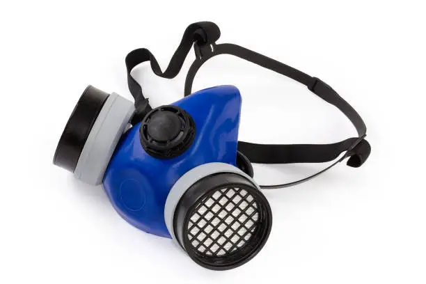 Reusable half-face elastomeric air-purifying respirator with replaceable filters on a white background