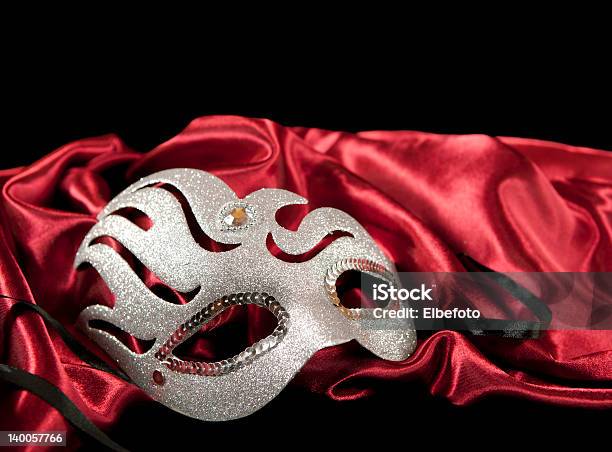 Silver Masquerade Mask On A Red Fabric Stock Photo - Download Image Now - Mask - Disguise, Musical Theater, Jester