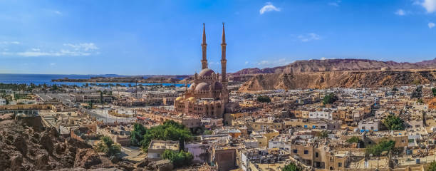 Widescreen panorama of the Old Market in Sharm El Sheikh with the Al Sahaba Mosque in the center and the Red Sea on the horizon stock photo