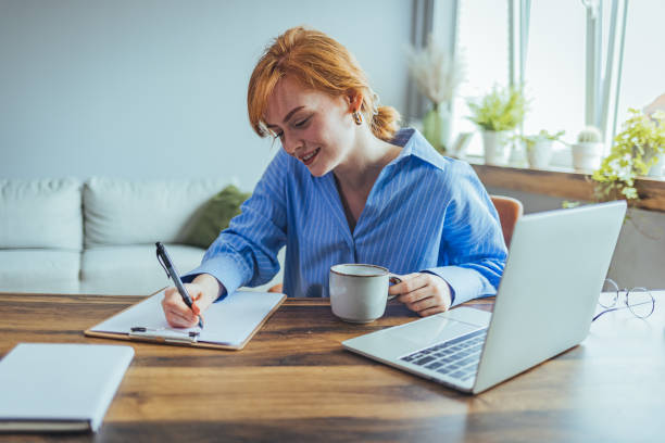 istock Smiling beauyiful girl preparing school homework 1400581469