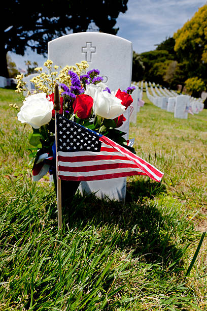 istock Headstone and American Flag at National Cemetery 140058215