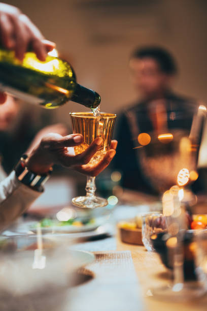 istock Unrecognizable Man Serving Drink To His Friends 1400584511