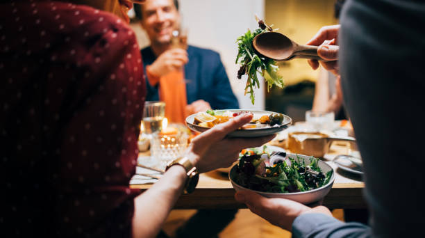 istock Unrecognizable Friends Sharing Food During A Dinner Celebration 1400584571