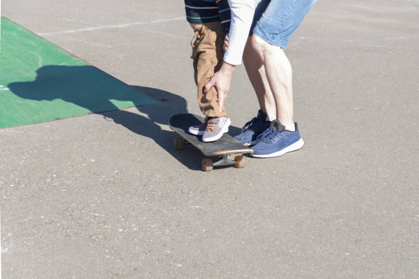 istock A caring and loving father teaches his three-year-old son to skateboard. 1400588965