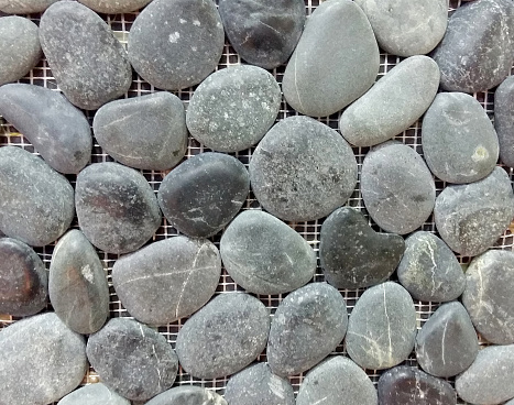 gray sea pebble stone wall texture background