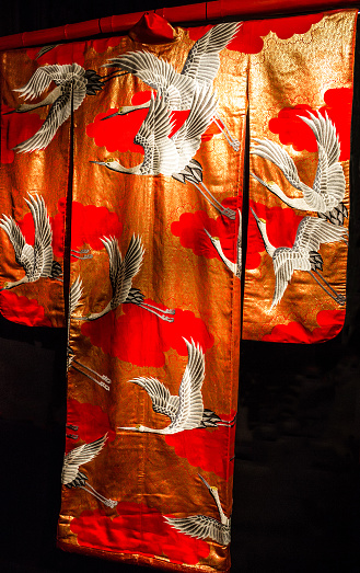 Kimono - Japanese national costume. Red embroidered textile.
