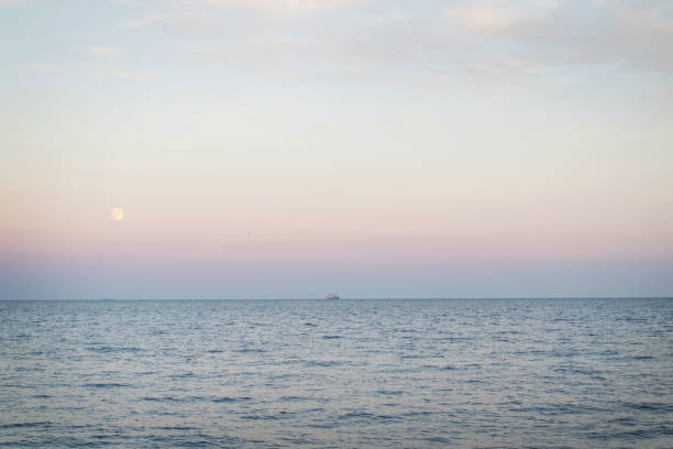 istock Calm sea with a ship sailing in the distance. 1400592350