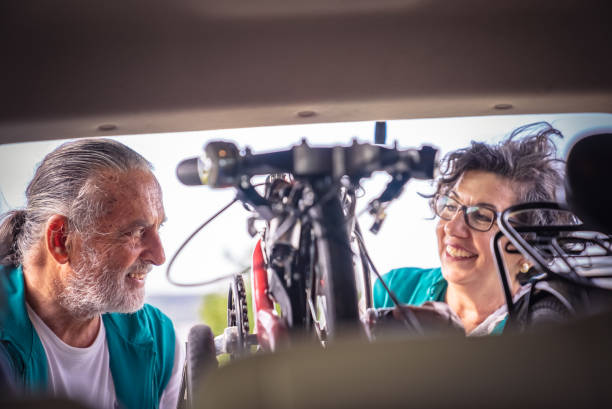 istock Retired Active Seniors putting bikes to car trunk 1400593393